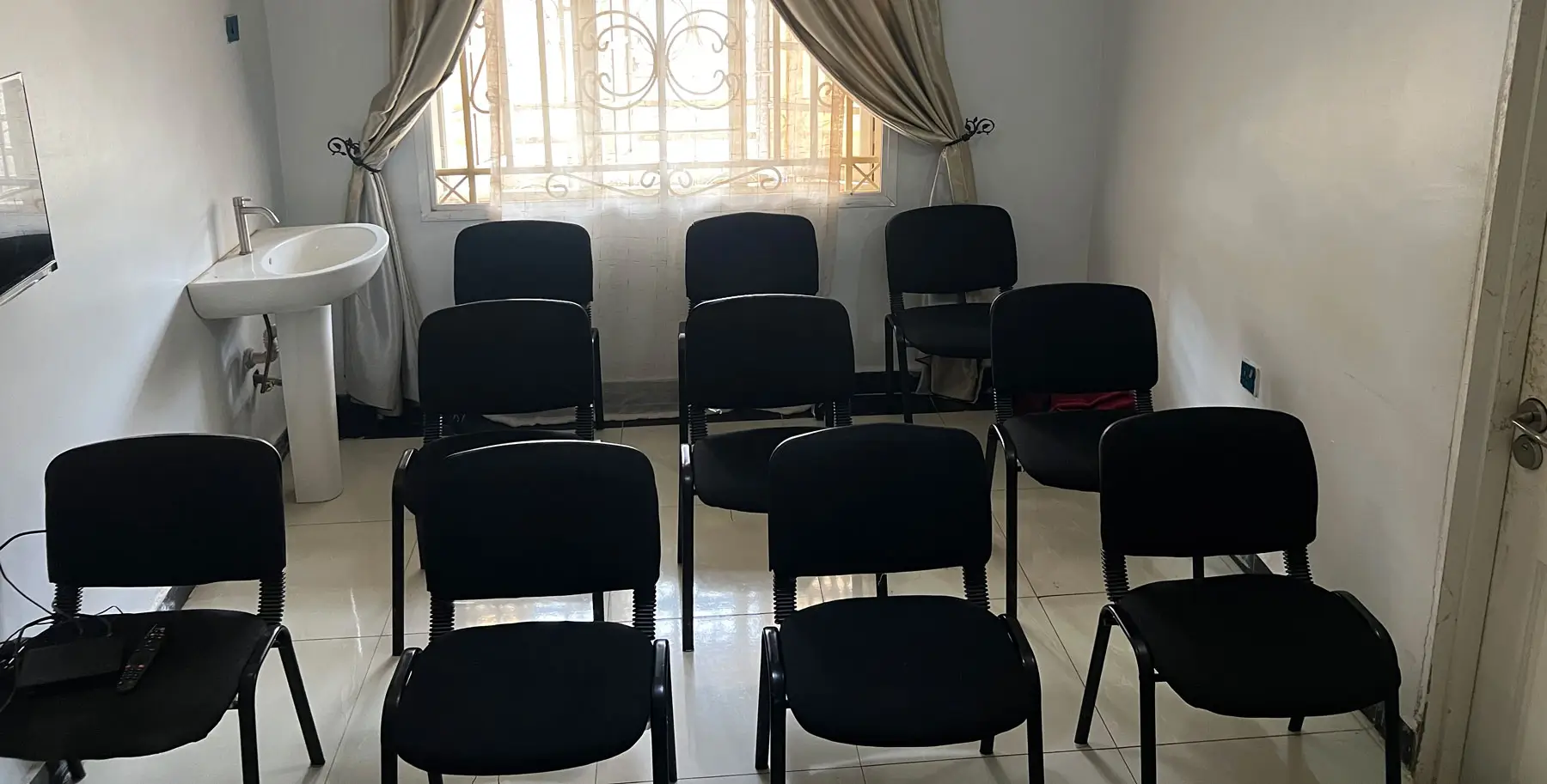 The group therapy room at Rahama Wellness Center, Abuja, with seating arranged in a circle beneath a daylit window