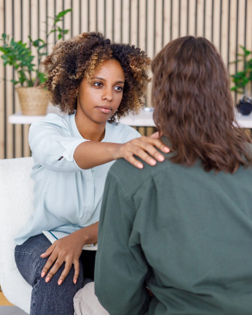African American female psychologist conducts an appointment with a patient in the office. mental health and moral support.
