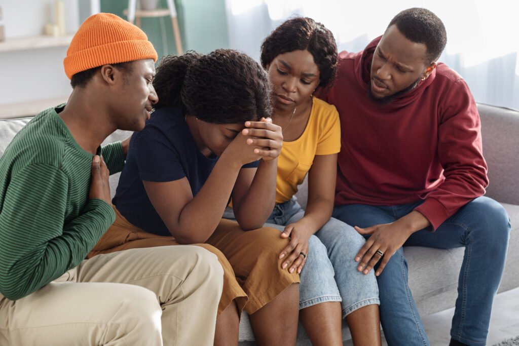 Supportive black friends consoling their crying girlfriend